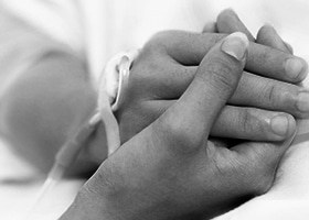 Holding a patient's hand