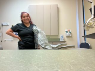 Smiling nurse in scrubs uniform in a medical setting