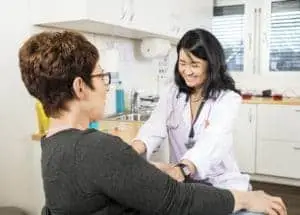 Phlebotomist Smiling Near Patient