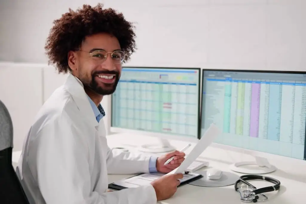 Male medical biller coding spreadsheets.